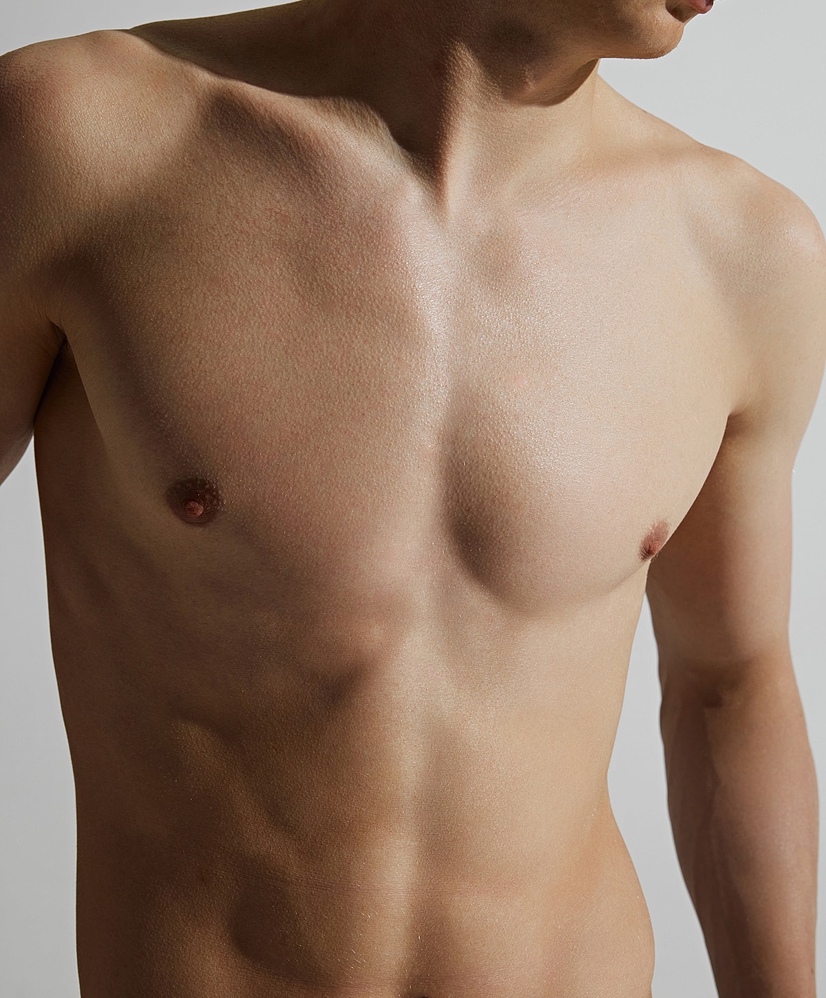 Close-up of a bare male torso.